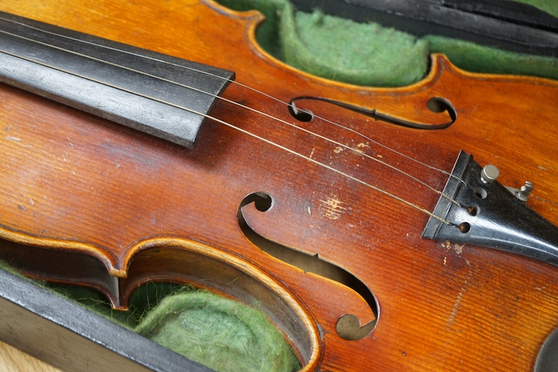 A 19th century cased violin and bow, body of violin 35.5cm long. Condition - needs restringing